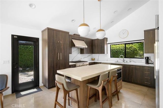 2305 Henrietta Ave, La Crescenta, CA 91214 - kitchen with range hood, a sink, light countertops, a breakfast bar area, and dark brown cabinets