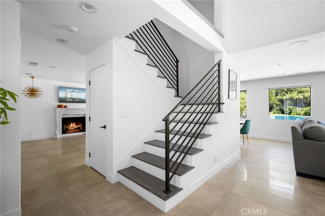 2305 Henrietta Ave, La Crescenta, CA 91214 - staircase with tile patterned floors, a warm lit fireplace, and baseboards