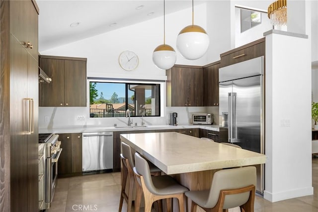 2305 Henrietta Ave, La Crescenta, CA 91214 - kitchen with high end appliances, a sink, modern cabinets, a kitchen breakfast bar, and light countertops