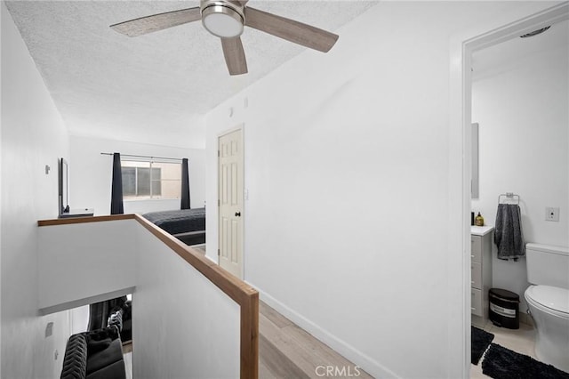11025 Kittridge St Unit 128, North Hollywood, CA 91606 - hall with a textured ceiling, wood finished floors, and an upstairs landing