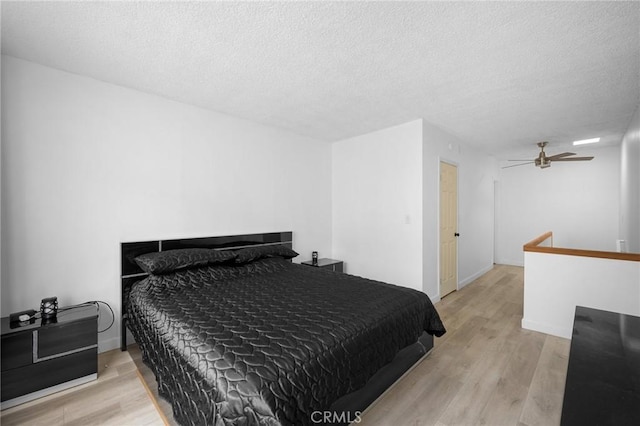 11025 Kittridge St Unit 128, North Hollywood, CA 91606 - bedroom with wood finished floors, a textured ceiling, a ceiling fan, and baseboards