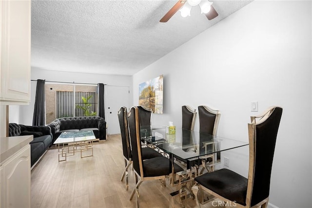 11025 Kittridge St Unit 128, North Hollywood, CA 91606 - dining room featuring a textured ceiling, ceiling fan, and light wood-type flooring
