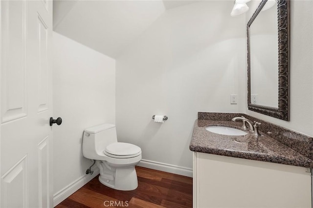 21 Mykonos, Laguna Niguel, CA 92677 - bathroom with toilet, wood finished floors, vanity, baseboards, and vaulted ceiling