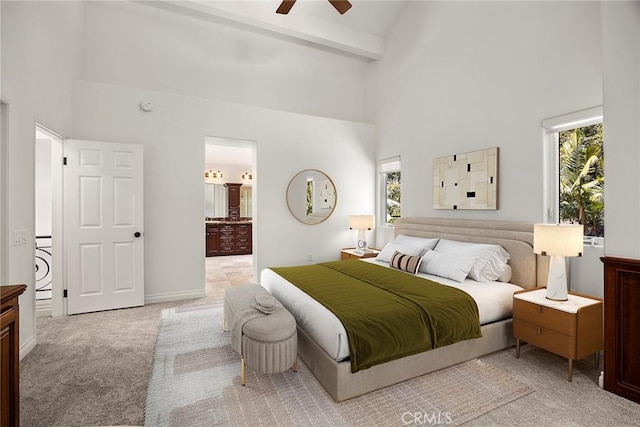 21 Mykonos, Laguna Niguel, CA 92677 - bedroom with high vaulted ceiling, light colored carpet, washer / clothes dryer, beam ceiling, and ensuite bathroom