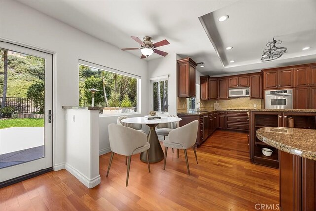 21 Mykonos, Laguna Niguel, CA 92677 - kitchen featuring appliances with stainless steel finishes, wood finished floors, recessed lighting, a sink, and backsplash