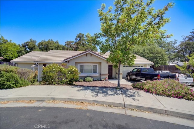 9024 Cascada Rd, Atascadero, CA 93422 - view of front facade featuring a garage, a tile roof, stucco siding, and concrete driveway