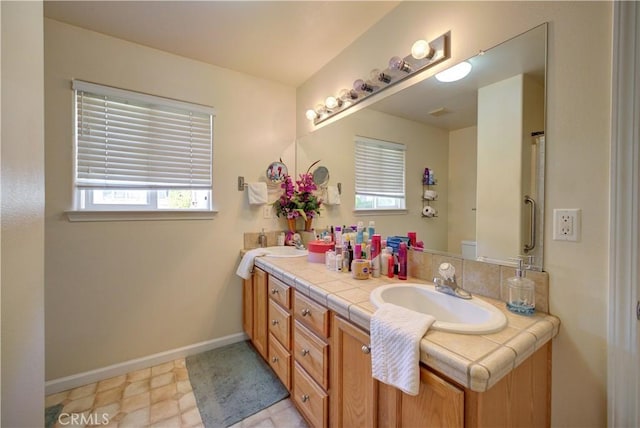 9024 Cascada Rd, Atascadero, CA 93422 - bathroom featuring double vanity, healthy amount of natural light, and baseboards