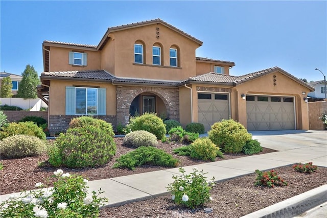 45668 Nora Cir, Temecula, CA 92592 - mediterranean / spanish-style house with an attached garage, concrete driveway, stucco siding, and a tile roof