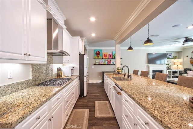 45668 Nora Cir, Temecula, CA 92592 - kitchen featuring wall chimney range hood, stainless steel appliances, a sink, white cabinets, and ornamental molding