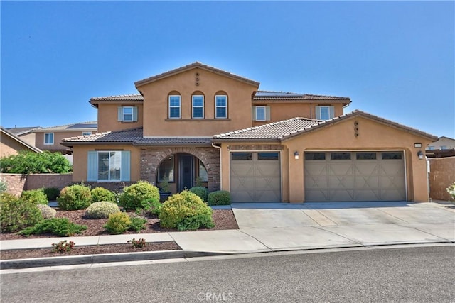 45668 Nora Cir, Temecula, CA 92592 - mediterranean / spanish-style house with solar panels, a garage, a tile roof, and stucco siding