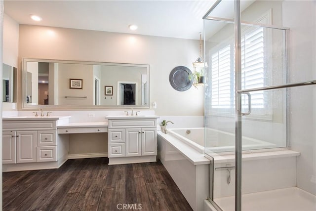 45668 Nora Cir, Temecula, CA 92592 - full bathroom with double vanity, a garden tub, wood finished floors, and an enclosed shower