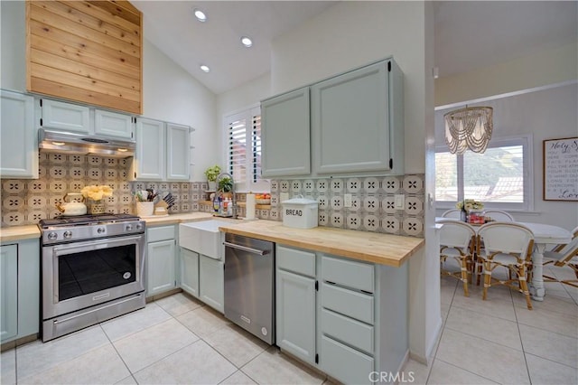 6456 Twinberry Cir, Avila Beach, CA 93424 - kitchen featuring stainless steel appliances, light tile patterned floors, backsplash, a chandelier, and lofted ceiling