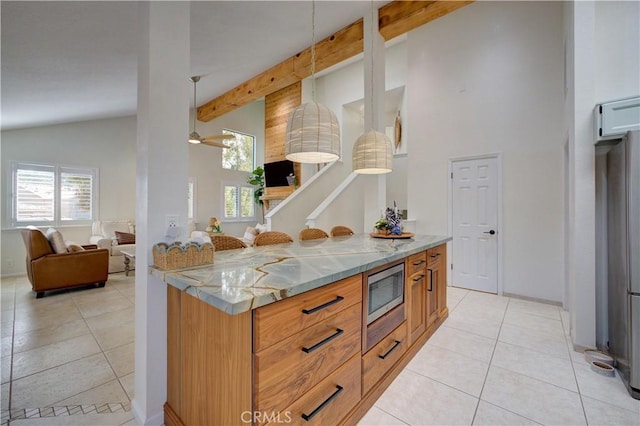 6456 Twinberry Cir, Avila Beach, CA 93424 - kitchen featuring stainless steel microwave, light tile patterned floors, open floor plan, high vaulted ceiling, and beam ceiling