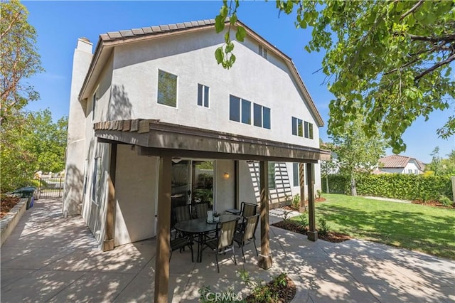 26520 Thackery Ln, Stevenson Ranch, CA 91381 - back of house with a patio area, stucco siding, and a chimney