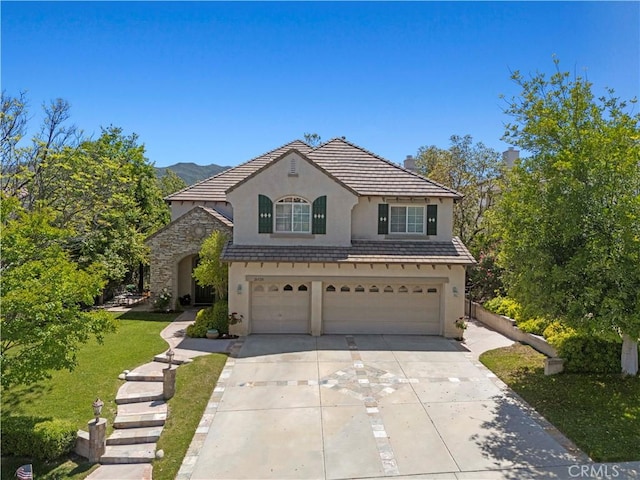 26520 Thackery Ln, Stevenson Ranch, CA 91381 - french country inspired facade with stucco siding, a garage, concrete driveway, stone siding, and a tiled roof