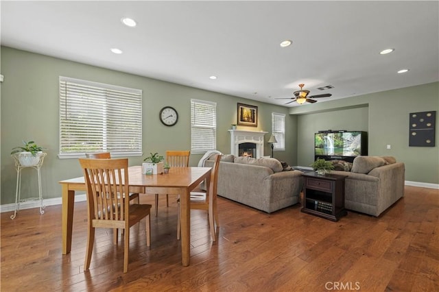 26520 Thackery Ln, Stevenson Ranch, CA 91381 - dining room with recessed lighting, a lit fireplace, ceiling fan, and wood finished floors