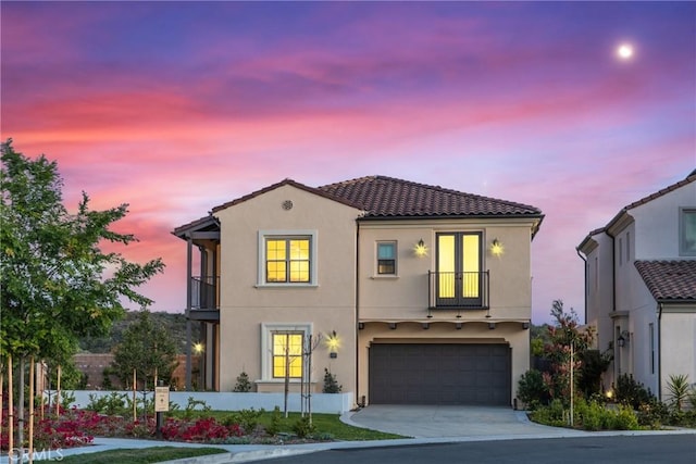 200 Canterbury, Irvine, CA 92618 - mediterranean / spanish-style house featuring a balcony, stucco siding, a garage, and concrete driveway