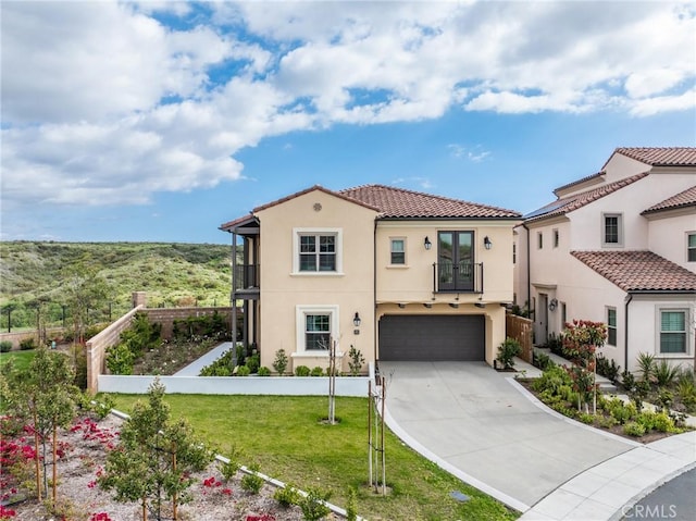 200 Canterbury, Irvine, CA 92618 - mediterranean / spanish-style house featuring concrete driveway, a garage, stucco siding, a balcony, and a front yard
