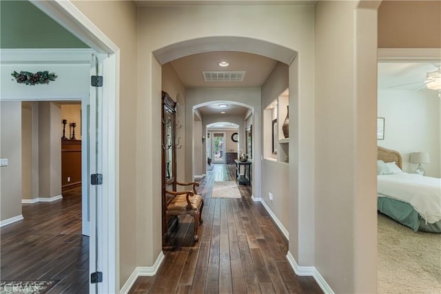 36702 Doreen Dr, Murrieta, CA 92563 - hall featuring arched walkways, dark wood-type flooring, and baseboards
