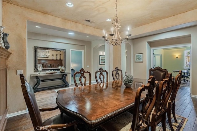 36702 Doreen Dr, Murrieta, CA 92563 - dining room with arched walkways, recessed lighting, wood finished floors, a chandelier, and baseboards