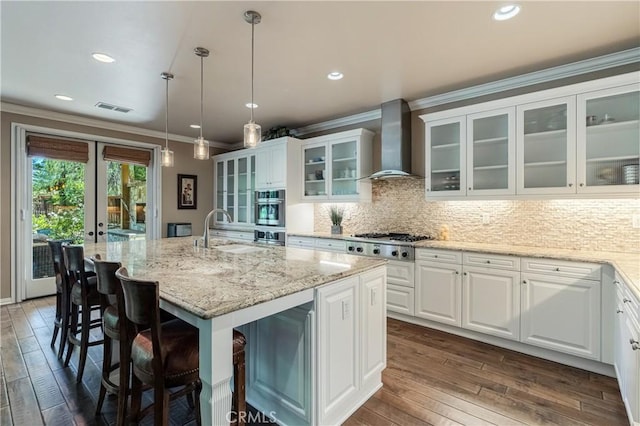 36702 Doreen Dr, Murrieta, CA 92563 - kitchen featuring wall chimney range hood, a sink, stainless steel gas stovetop, dark wood-type flooring, and ornamental molding