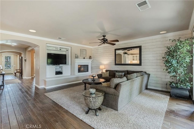 36702 Doreen Dr, Murrieta, CA 92563 - living area with arched walkways, a ceiling fan, baseboards, dark wood-type flooring, and wooden walls