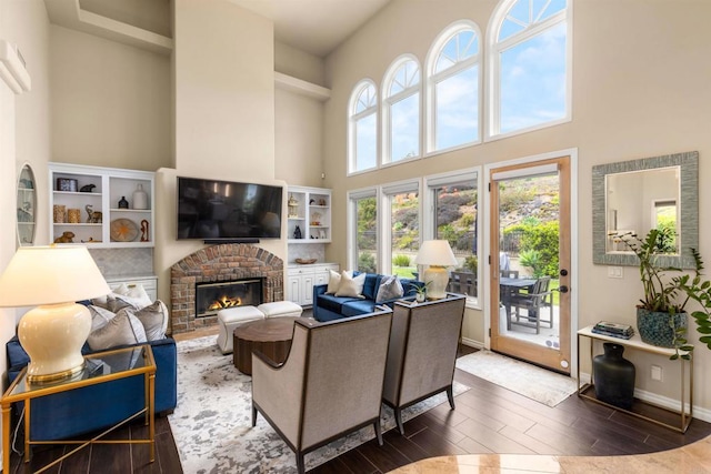 9698 Welk View Dr, Escondido, CA 92026 - living area featuring a towering ceiling, wood finished floors, and a brick fireplace