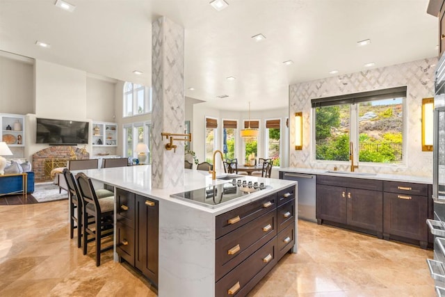 9698 Welk View Dr, Escondido, CA 92026 - kitchen featuring stainless steel dishwasher, electric stovetop, a breakfast bar area, dark brown cabinetry, and a large island