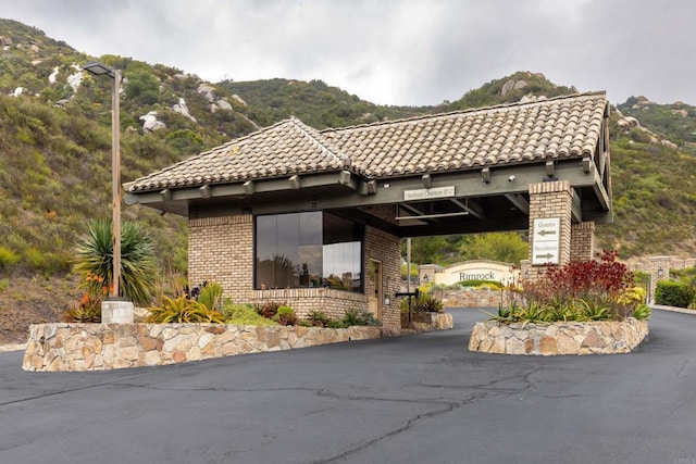 9698 Welk View Dr, Escondido, CA 92026 - view of home's exterior featuring a tiled roof, a mountain view, brick siding, and driveway