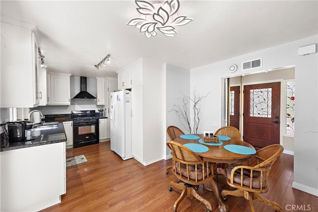 27972 Via Chocano, Mission Viejo, CA 92692 - dining area with light wood finished floors, baseboards, and track lighting