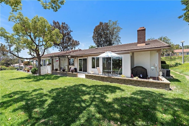 27972 Via Chocano, Mission Viejo, CA 92692 - back of property featuring a chimney, a lawn, central AC, stucco siding, and a tiled roof