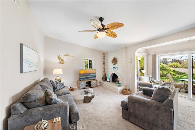 27972 Via Chocano, Mission Viejo, CA 92692 - carpeted living area with plenty of natural light, arched walkways, a ceiling fan, and a fireplace