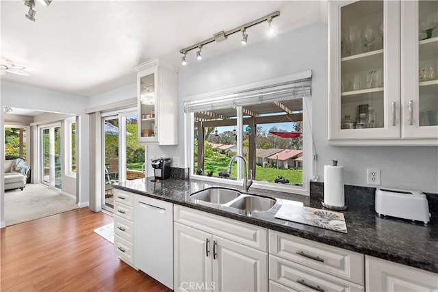27972 Via Chocano, Mission Viejo, CA 92692 - kitchen featuring a sink, dishwasher, track lighting, white cabinets, and dark stone countertops