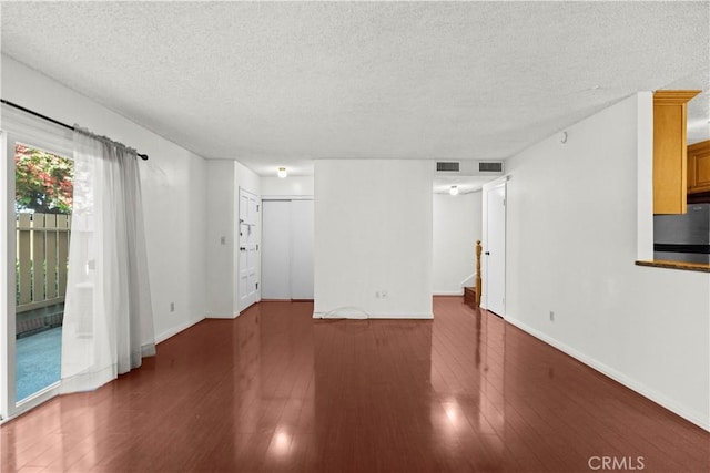 2300 S Hacienda Blvd Unit F8, Hacienda Heights, CA 91745 - unfurnished living room featuring a textured ceiling, wood finished floors, and baseboards