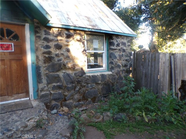 3688 Koloko St, Clearlake, CA 95422 - view of side of home with stone siding and metal roof