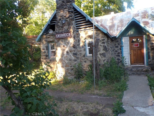 3688 Koloko St, Clearlake, CA 95422 - view of front of property with a chimney and stone siding