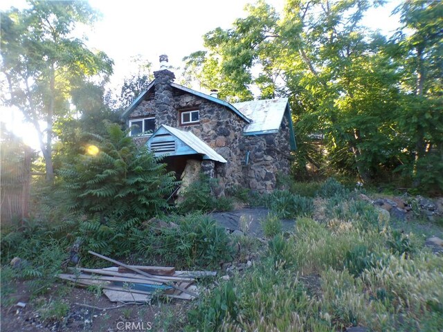 3688 Koloko St, Clearlake, CA 95422 - view of side of property with stone siding and a chimney