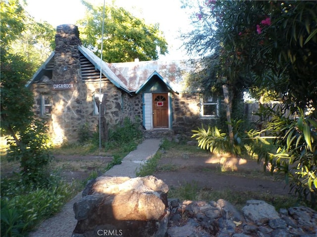 3688 Koloko St, Clearlake, CA 95422 - view of front facade with a chimney and stone siding