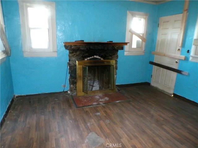3688 Koloko St, Clearlake, CA 95422 - unfurnished living room featuring healthy amount of natural light, wood finished floors, baseboards, a stone fireplace, and crown molding