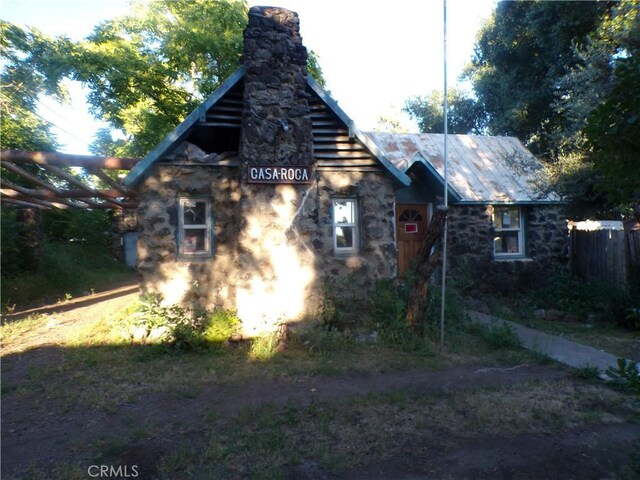 3688 Koloko St, Clearlake, CA 95422 - view of side of home featuring a chimney and stone siding