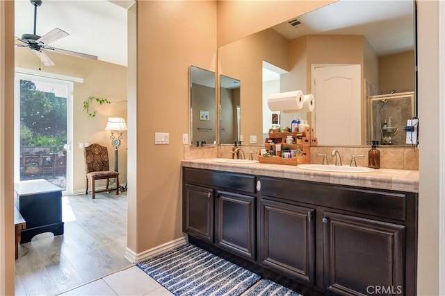 10460 Meadow Lark Ave, Moreno Valley, CA 92557 - bathroom with double vanity, ceiling fan, a shower with door, and tasteful backsplash