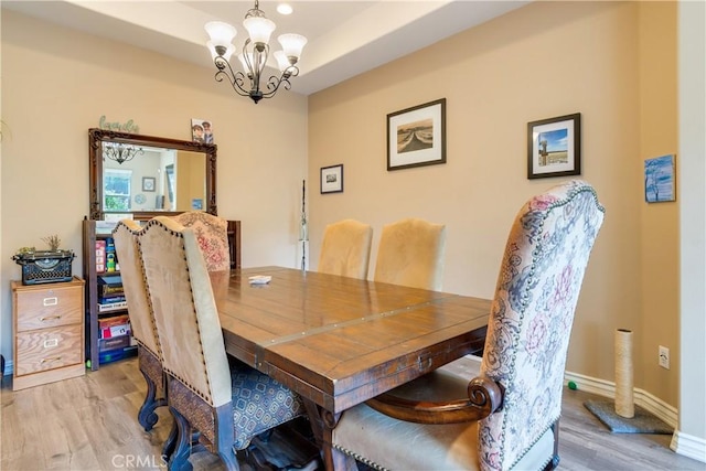 10460 Meadow Lark Ave, Moreno Valley, CA 92557 - dining area featuring a chandelier, light wood-style floors, and baseboards