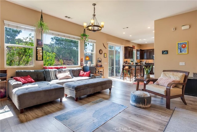 10460 Meadow Lark Ave, Moreno Valley, CA 92557 - living room featuring plenty of natural light, a chandelier, wood finished floors, and recessed lighting