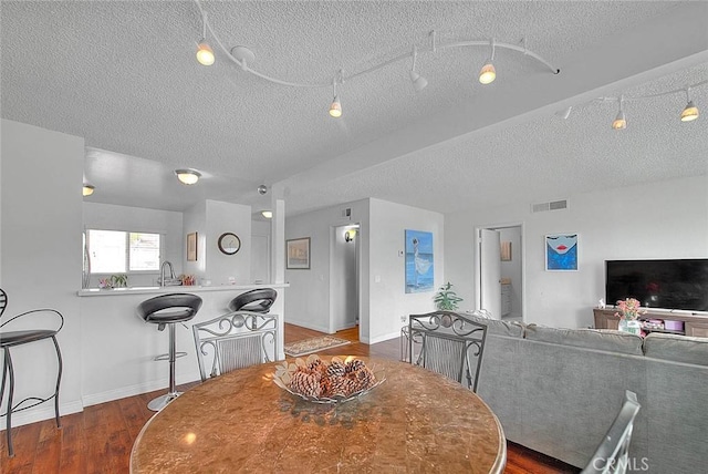 2940 N Verdugo Rd Unit 409, Glendale, CA 91208 - dining space with a textured ceiling, wood finished floors, and baseboards