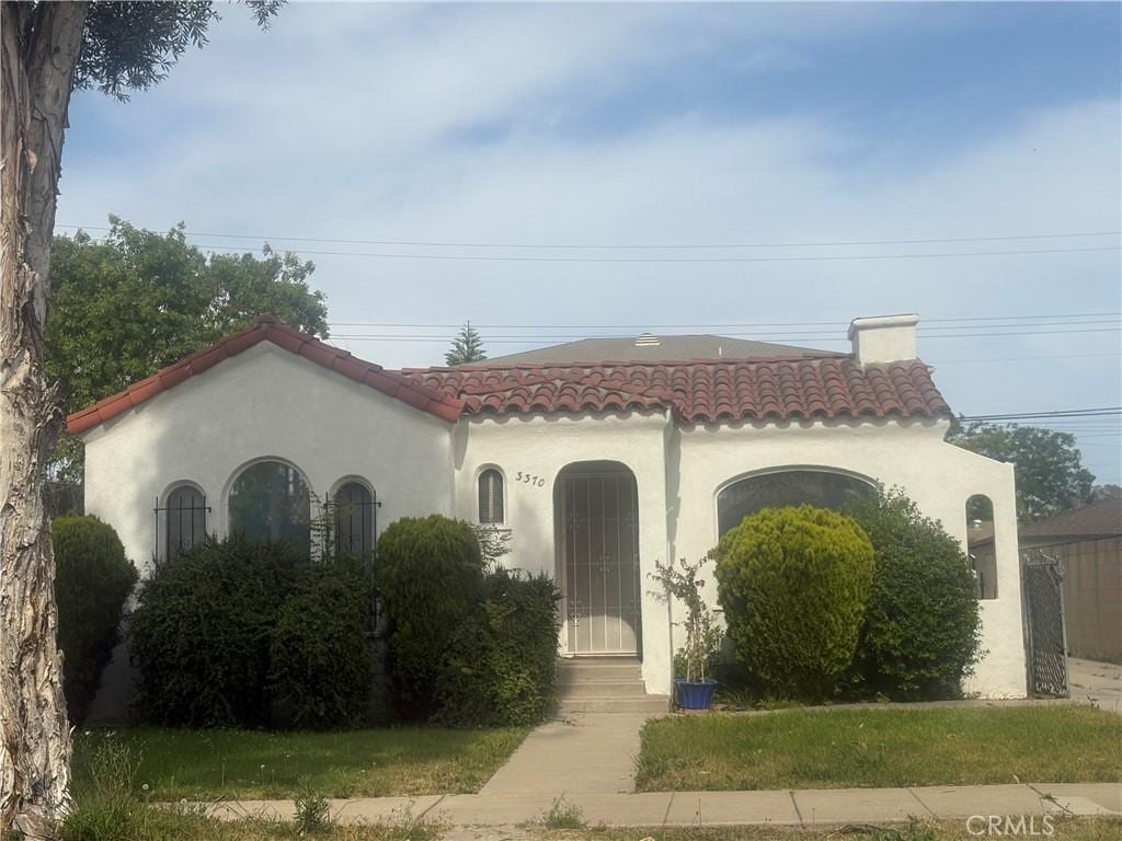 33703372 Lemon Ave Unit 2, Signal Hill, CA 90755 - mediterranean / spanish house with a tiled roof, a chimney, and stucco siding