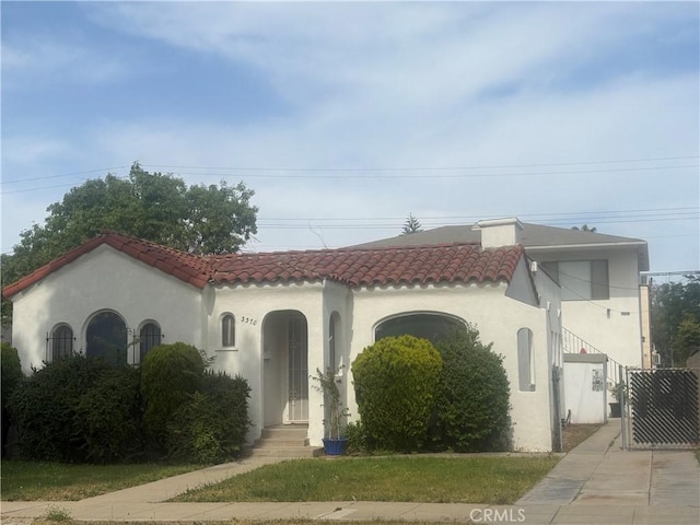 33703372 Lemon Ave Unit 2, Signal Hill, CA 90755 - mediterranean / spanish-style house with a tiled roof and stucco siding