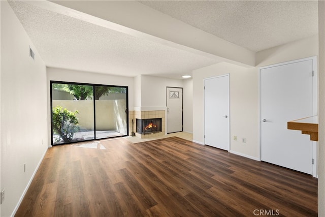 13115 Le Parc, Chino Hills, CA 91709 - unfurnished living room featuring a fireplace, wood finished floors, a textured ceiling, and baseboards