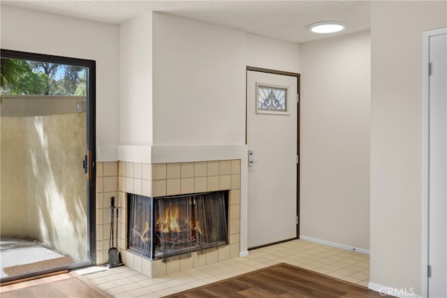 13115 Le Parc, Chino Hills, CA 91709 - detailed view of a textured ceiling, a tile fireplace, wood finished floors, and baseboards