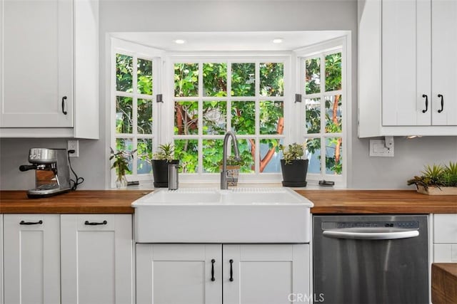 19172 Sierra Maria Rd, Irvine, CA 92603 - kitchen with wooden counters, stainless steel dishwasher, a sink, and white cabinetry
