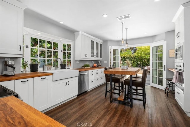 19172 Sierra Maria Rd, Irvine, CA 92603 - kitchen with butcher block counters, appliances with stainless steel finishes, dark wood-type flooring, a sink, and recessed lighting